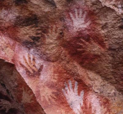 Whose hands are these etched in South America at the dawn of history?